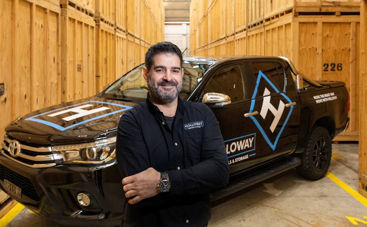 Chris from Holloway, standing in front of a ute in the Wolli Creek storage warehouse