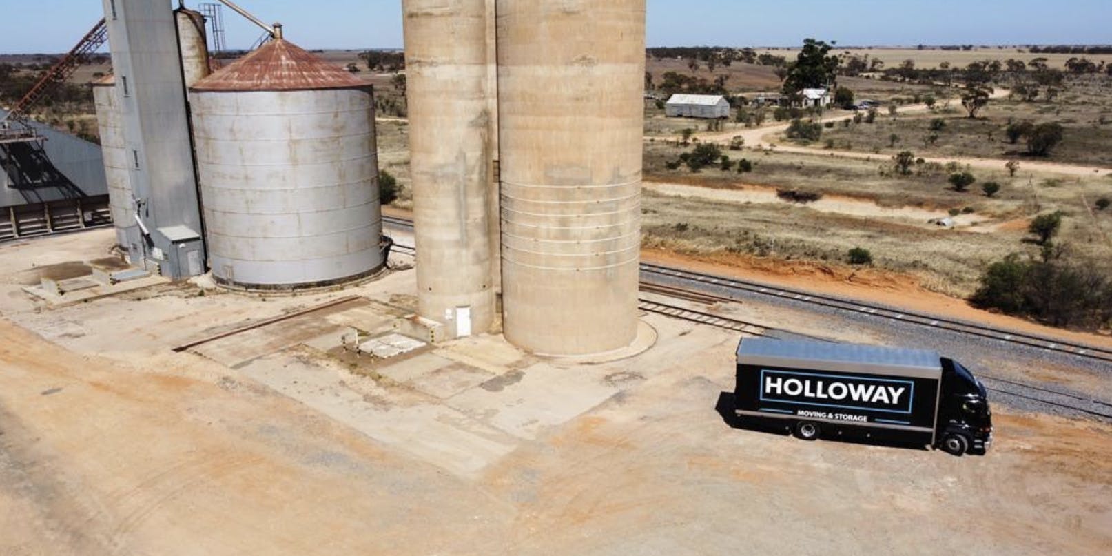 Holloway truck parked next to a silo