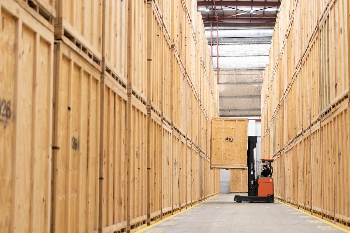 Forklift in a warehouse moving a storage module