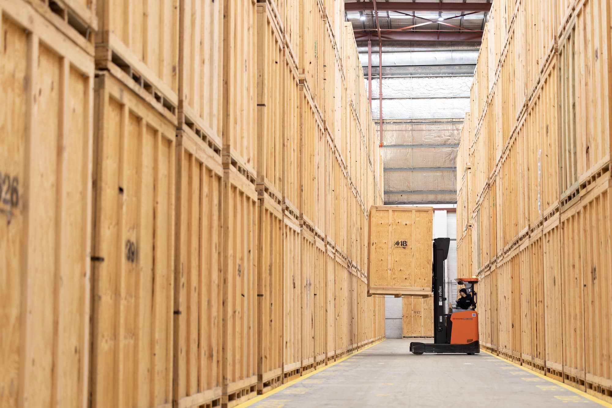 Forklift in a warehouse moving a storage module