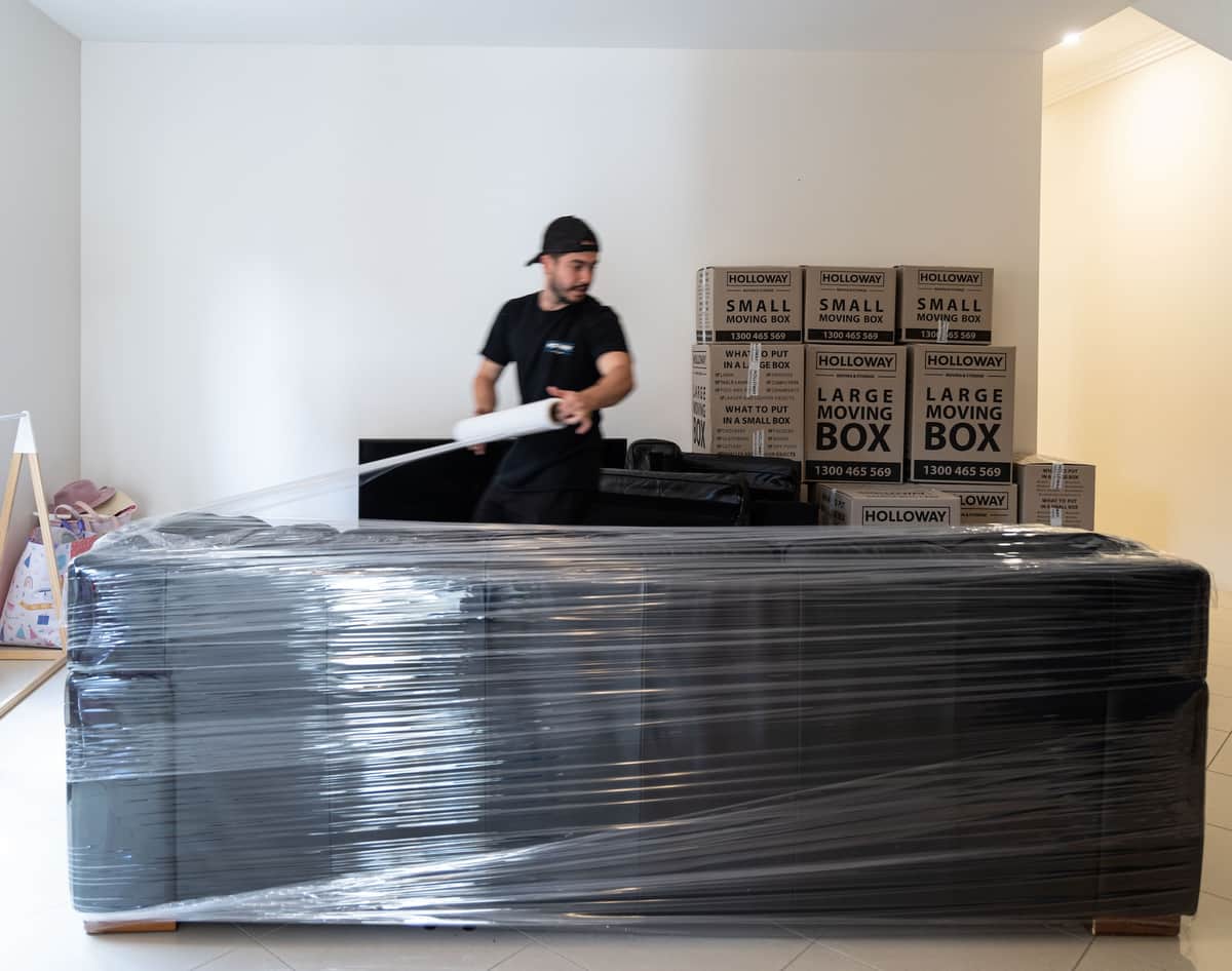 Removalists wrapping furniture