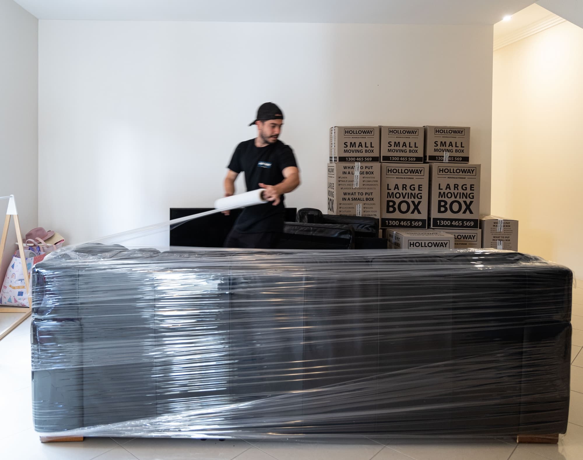 Removalists wrapping furniture