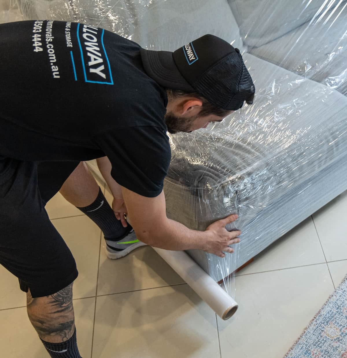 Removalists wrapping furniture