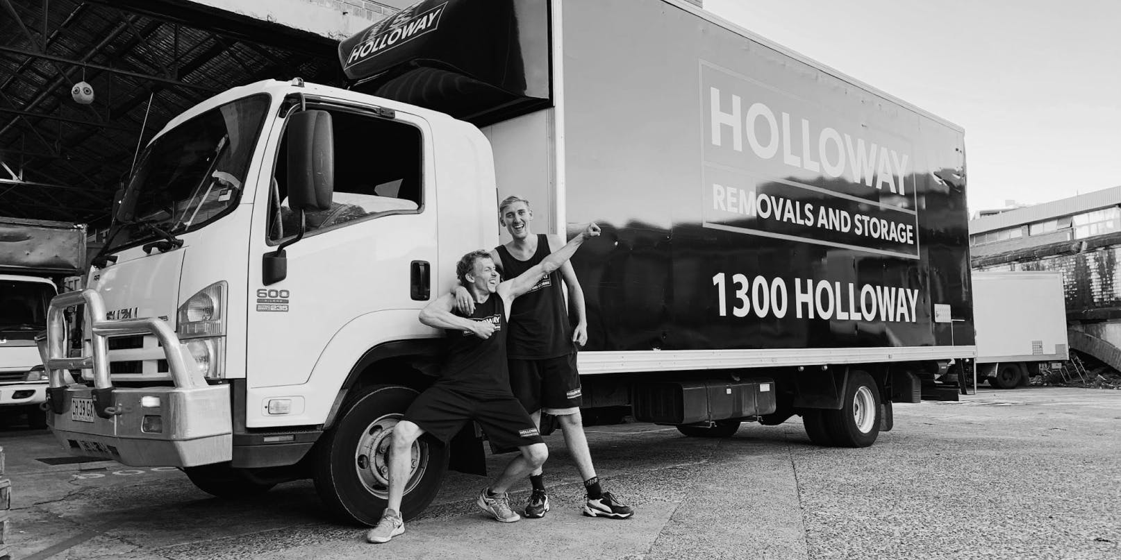 Holloway team posing in front of a truck