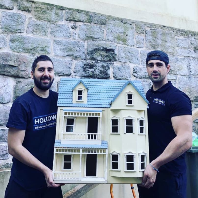 Holloway team showing us a model house they are moving