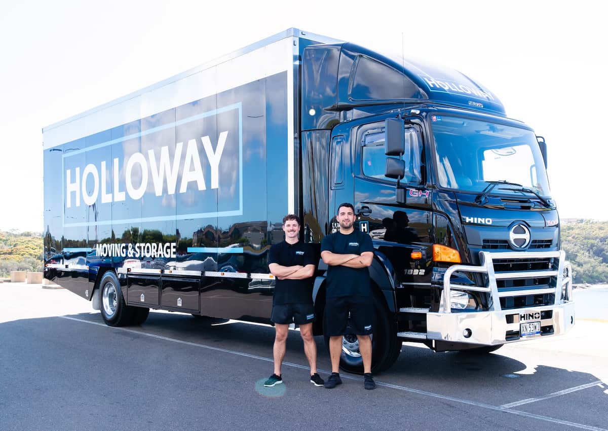 Holloway team posing in front of a truck