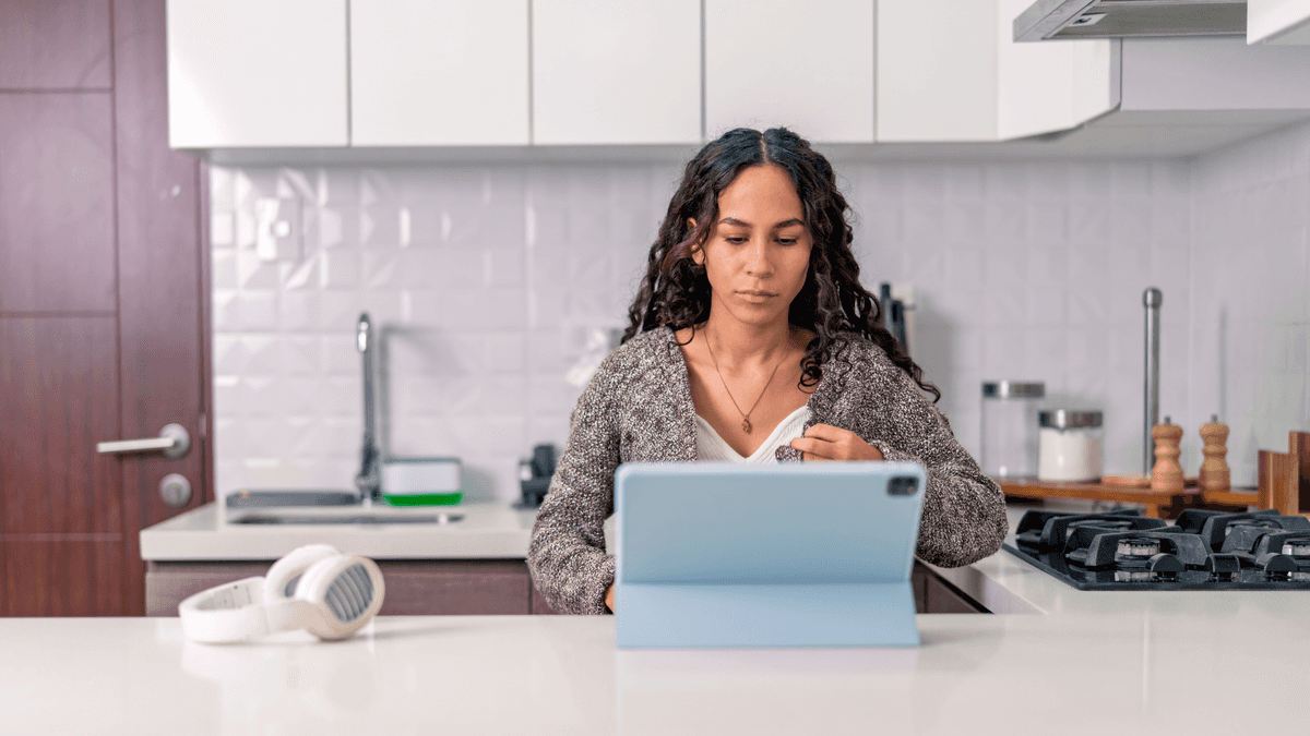 airbnb host managing her property on a tablet in her kitchen
