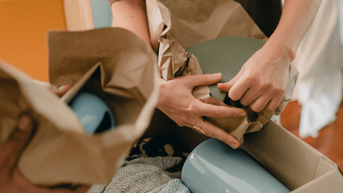 Kitchen items wrapped in paper and clothing for moving house