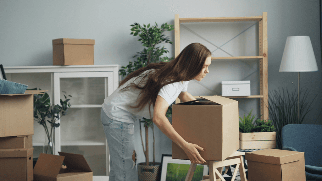woman moving boxes for a house move