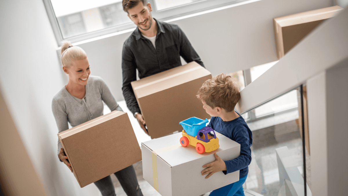 family moving boxes up stairs
