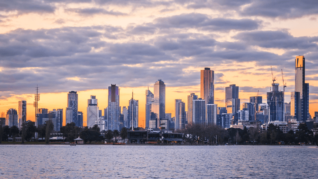 Melbourne skyline at sunset, featuring tall skyscrapers on Albert Park
