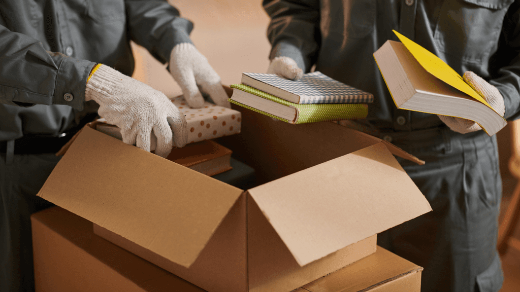 removalists packing books for moving day