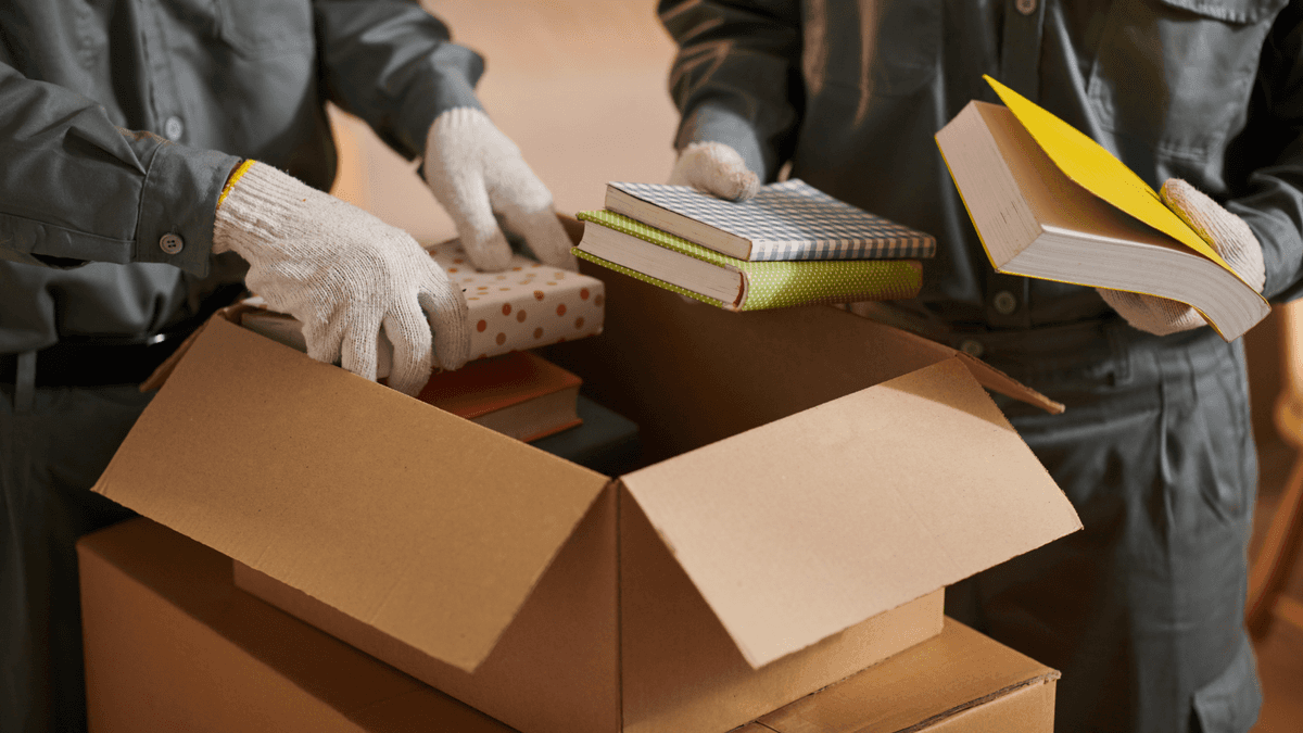 removalists packing books for moving day