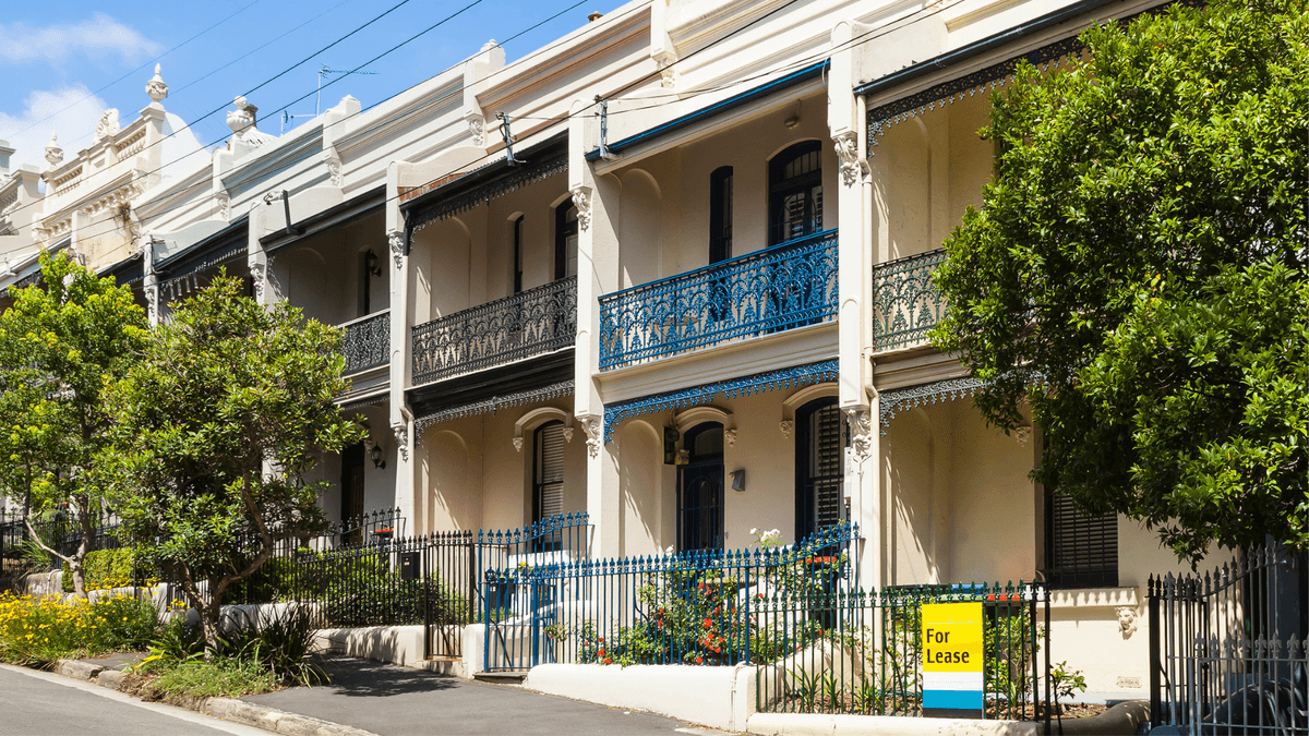 Row of terrace houses on a Sydney street, with a "For Lease" sign out front.