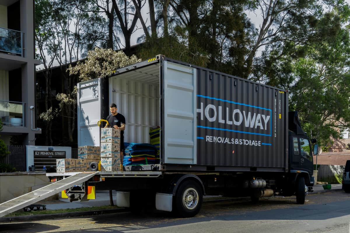 holloway removals moving truck outside an apartment on moving day