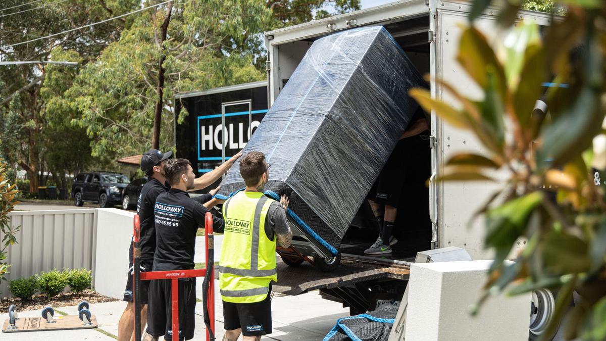 holloway removals removalists loading a fridge into a moving truck melbourne