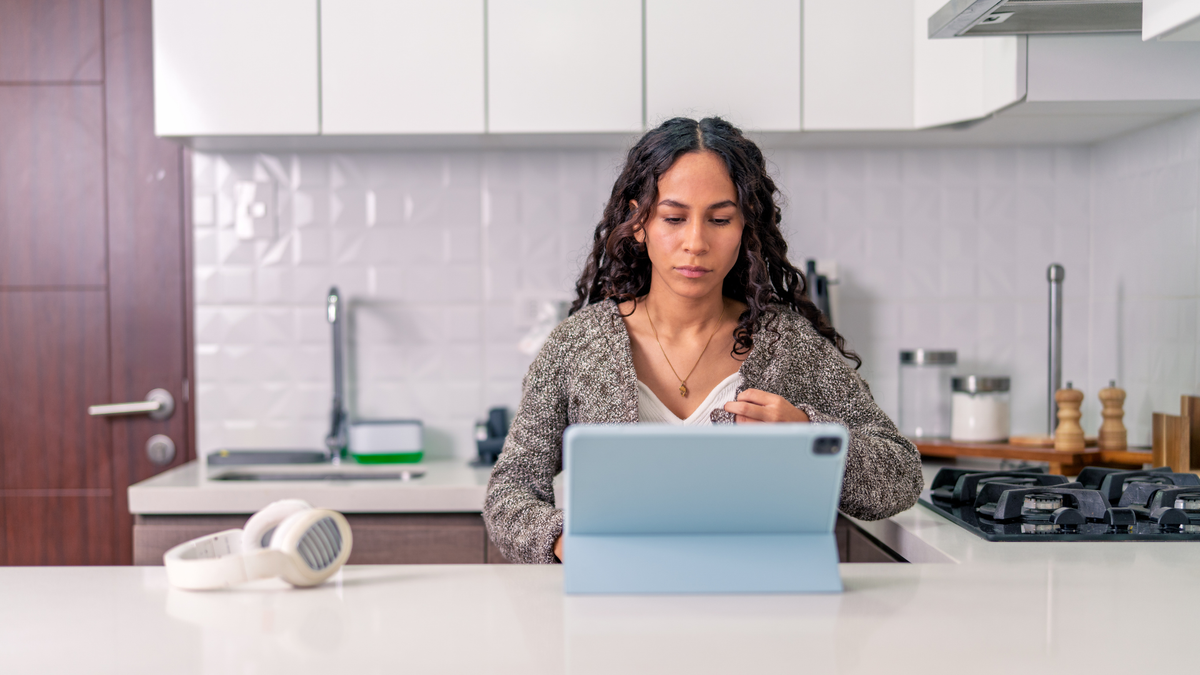 airbnb host managing her property on a tablet in her kitchen