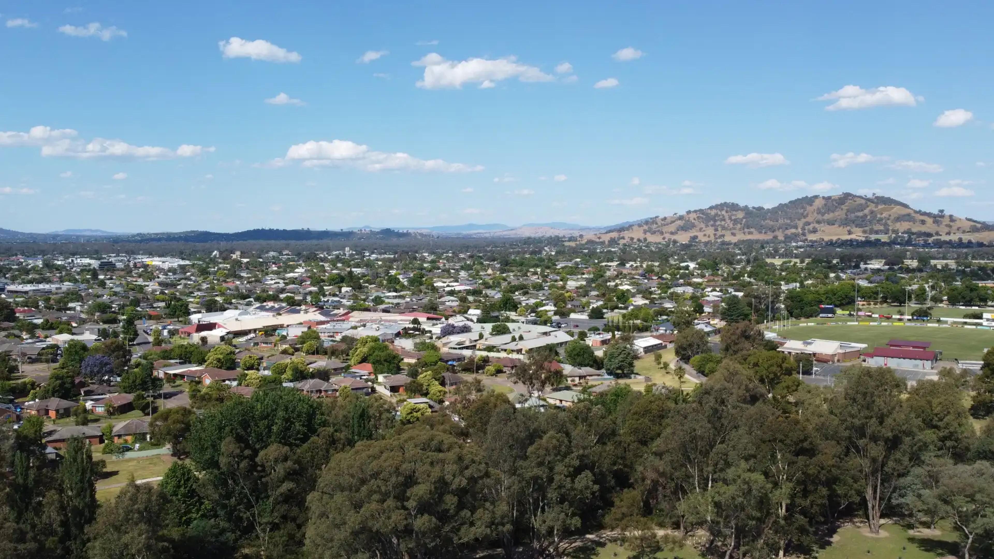aerial view of a Wodonga town with hills and green spaces in the background