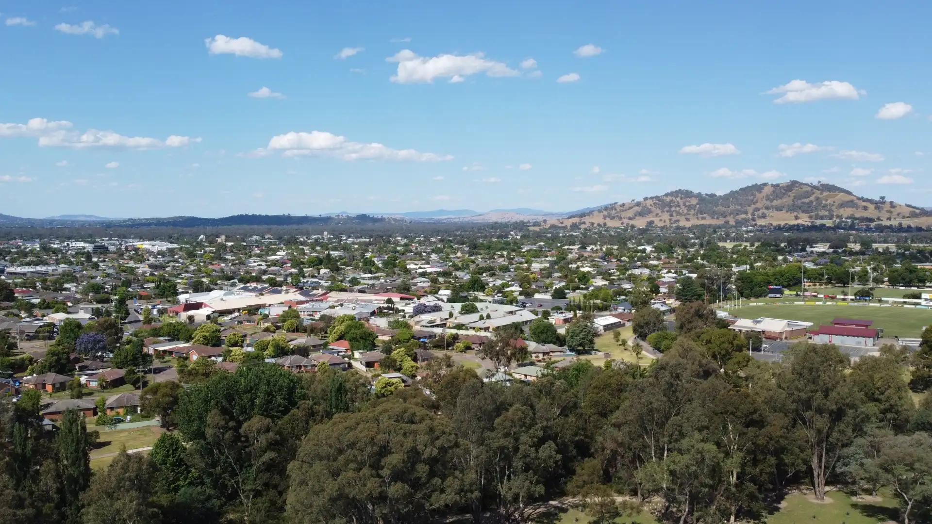 aerial view of a Wodonga town with hills and green spaces in the background