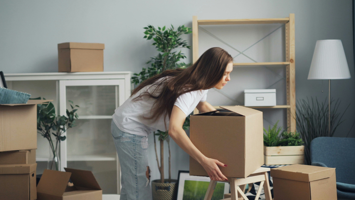 woman moving boxes for a house move