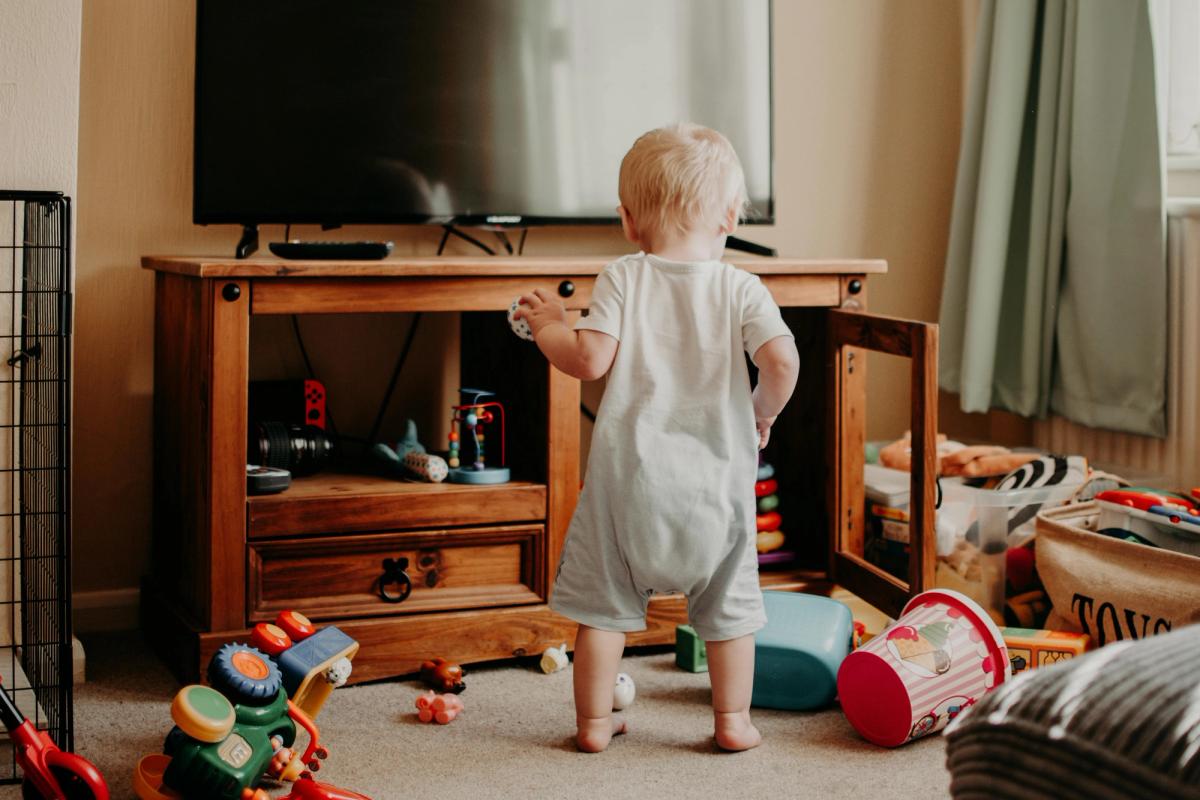toddler playing with toys in living room