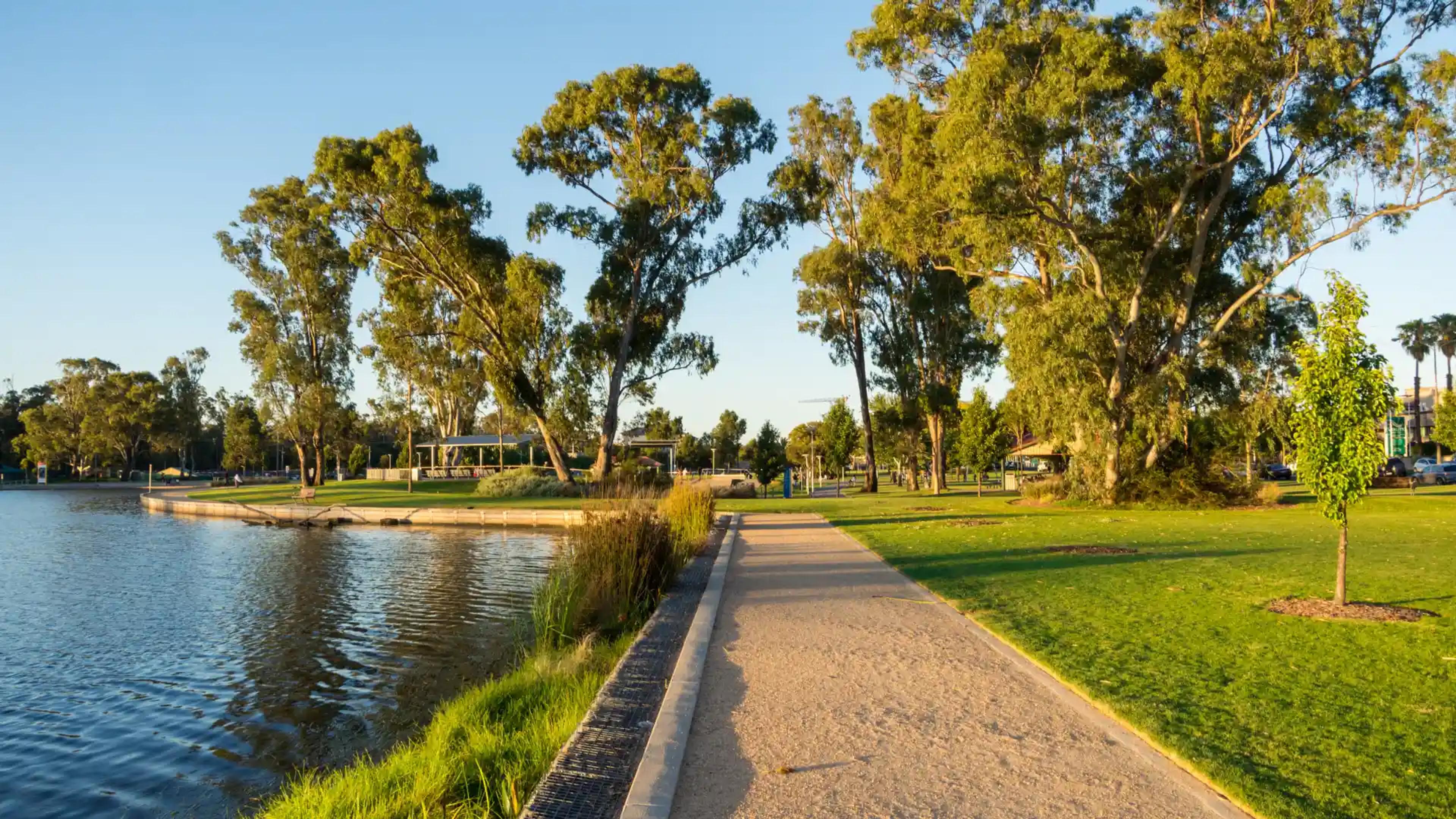 Sunset view of the walking path at Victoria Park Lake in Shepparton