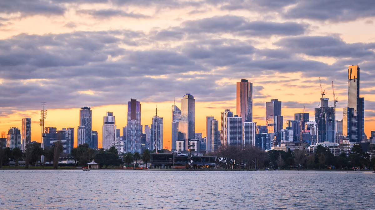 Melbourne skyline at sunset, featuring tall skyscrapers on Albert Park