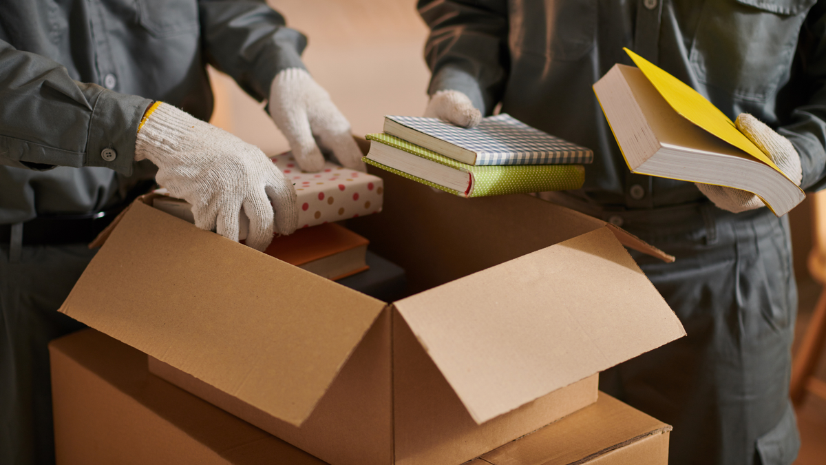 removalists packing books for moving day