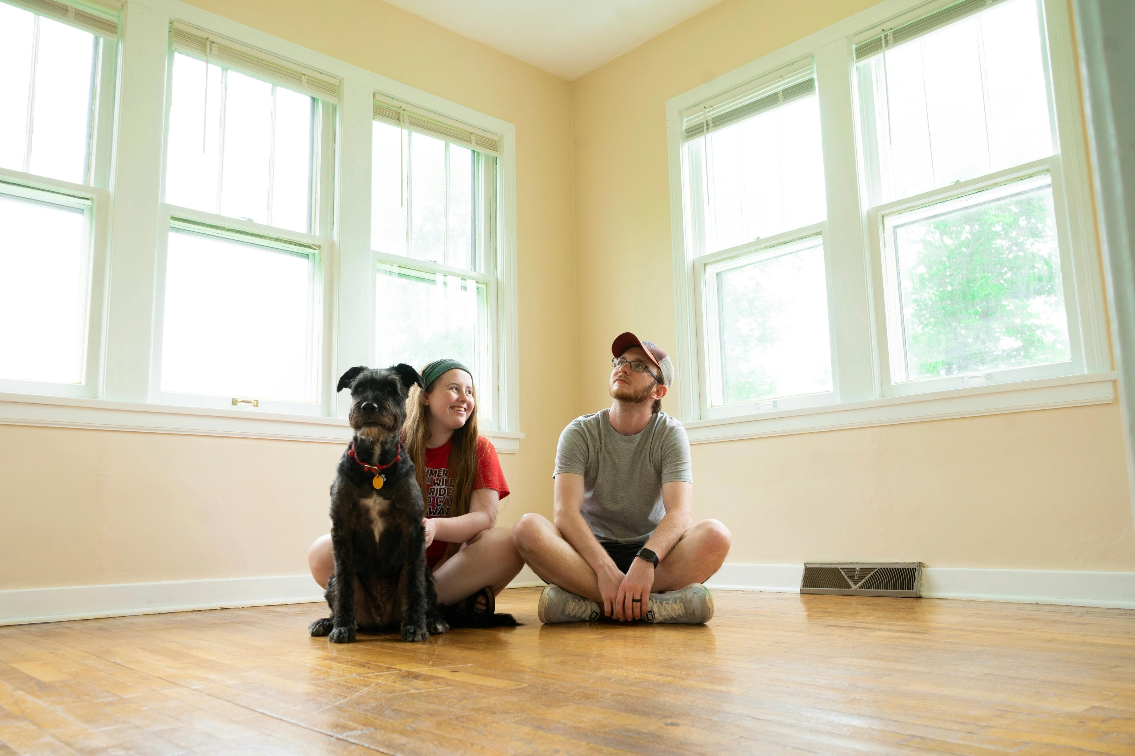 Man, woman, and dog in new home