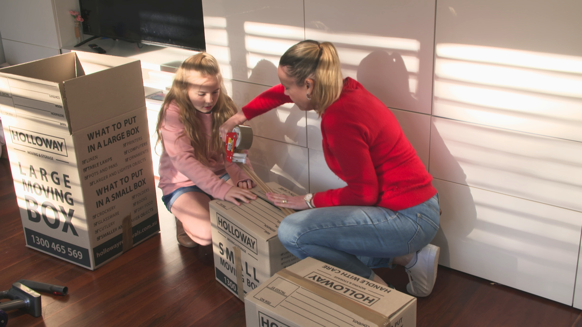 Mother and daughter packing boxes for house move Sydney